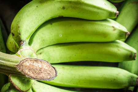 Fresh bananas on wooden background in the fruit market,Healthy food, bananas rich in vitamins, healthy lifestyle and prevention of vitamin deficiency.の写真素材