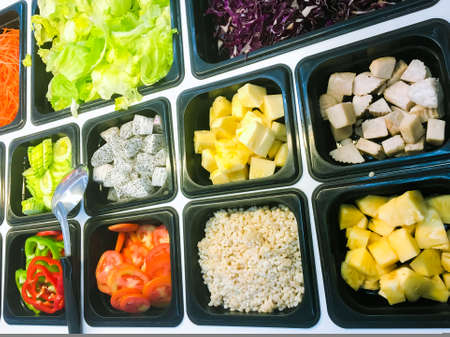 business people group in the line catering buffet food indoor in luxury restaurant with meat colorful rice and vegetablesの写真素材