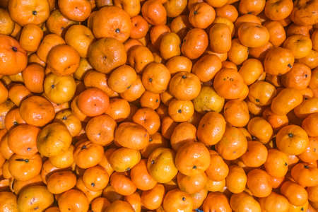 Colorful background Of Oranges In Fruit Market,Fresh mandarin oranges texture in a boxの写真素材