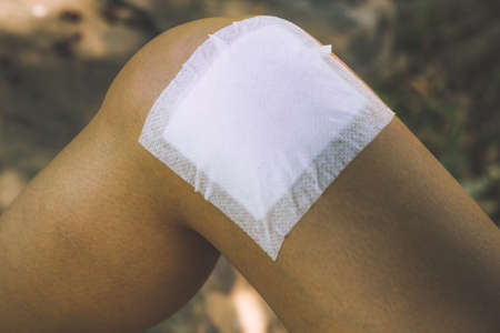 Women has inflammation and swelling cause a pain the sore knee, Healthy lifestyle and Women touch legs and feel pain. concept of injuries from exercising.の写真素材