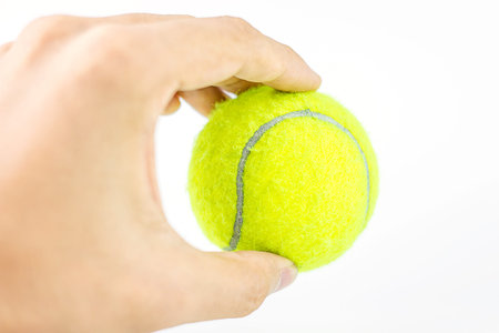 beautiful hands holding tennis ballの写真素材