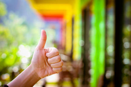 thumb up hand sign. woman hand showing thumb up, like, good, approval, acceptance, okay, ok, positive hand gestureの写真素材