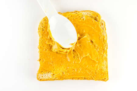 preparing breakfast toast with peanut butter sandwich.の写真素材