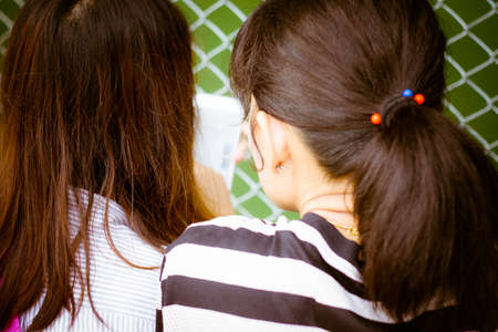 Happy young Asian woman with smartphone,Young female is reading information on web page via her mobile phone,Woman typing text message on smart phoneの写真素材