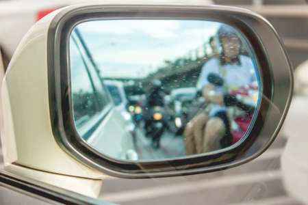 Background defocus reflection of a traffic jam in a sideview mirrorの写真素材