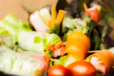 Close up of fresh salad of lettuce, cucumber and tomato on plate for healthy eating.
Fresh vegetable salad in Black plate  on wood table. Salad for healthy. Fresh raw vegetables salad background.の写真素材