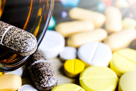 Medicine pills or capsules on wood background.Drug prescription for treatment medication.Pharmaceutical medicament,cure for health.Pharmacy theme, capsule pills with medicine antibiotic in packages.の写真素材