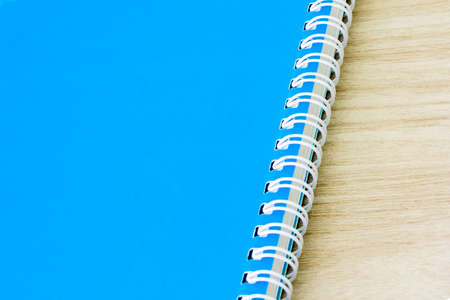 Blank blue book empty cover book spiral stationery school supplies for education business idea book cover design note pad memo on wooden background.の写真素材