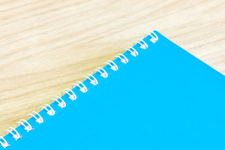 Blank blue book empty cover book spiral stationery school supplies for education business idea book cover design note pad memo on wooden background.の写真素材
