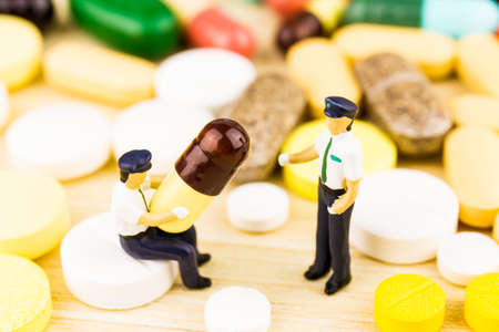Medicine pills or capsules on wood background. Drug prescription for treatment medication.の写真素材