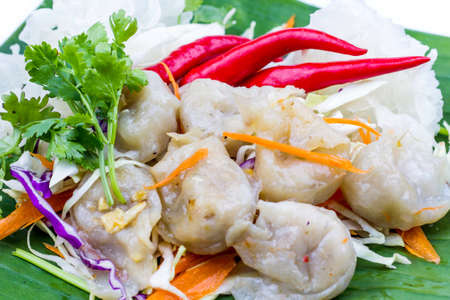 Fish dumpling with sauce on white plate, Thai food in thailand isolated over white background.の写真素材