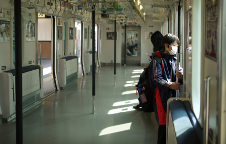 TOKYO - MARCH 28, 2012: Unidentified child on a train goes to school in the morning in Tokyo Japan.