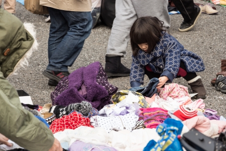 Harajuku, Japan - December 8, 2013  Unidentified children choose the second hand clothes at flea market in Yoyogi Park, Harajuku  It is the winter flea market in the city of fashion Harajuku, Japan のeditorial素材