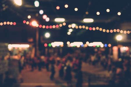 Blurred Bokeh background of night and people on streetの写真素材