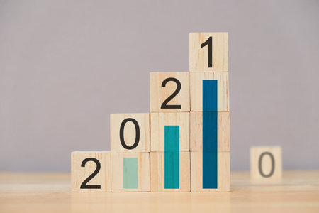 2021 strategy business growth concept. graph corporate future growth year of 2021, numbers 2021 on wooden cube.の写真素材