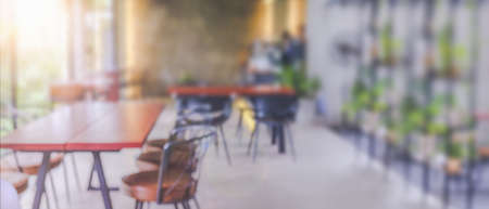 Abstract blur coffee shop cafe interior for background. Blurred background made with Vintage Tones,Coffee shop blur background with sunlight.の写真素材