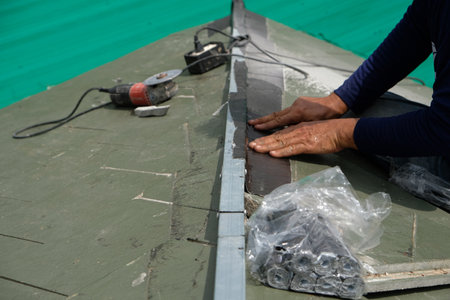 Leaky roof problem, New construction home roof repair service, Roofer at work, installing clay roof tiles,Construction installing roof tiles at house building siteの写真素材