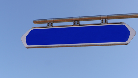 Template. Blue road sign with empty space and sky on a backgroundの写真素材