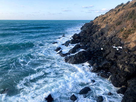 Solidified lava near water of sea in Jeju island. South Korea