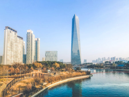 Autumn in Central Park of Incheon city. High buildings under a lake. South Korea