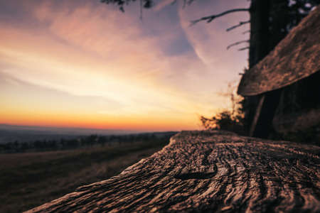 weathered old bench on a hill in sunsetの写真素材