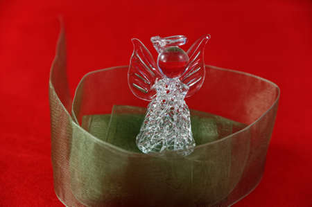 Delicate green ribbon surrounds a crystal angelの写真素材