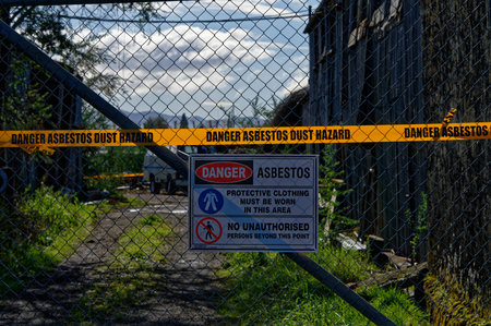 Bright yellow tapes warns people of the danger of asbestos dust