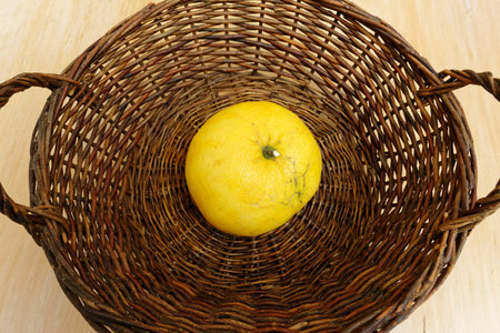 Brown woven basket with a large grapefruit