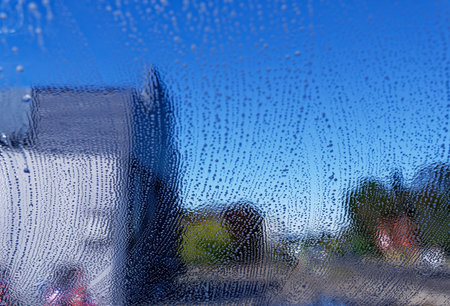 Looking out through a window that is being washedの写真素材