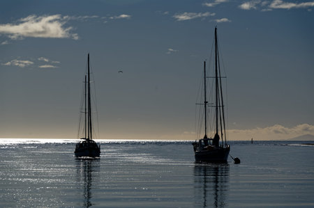 Two boats are moored at dusk