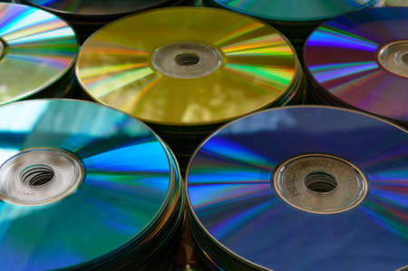Multiple stacks of DVDs of different coloursの写真素材