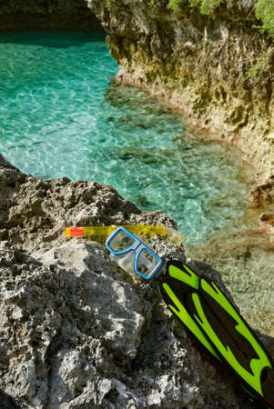 A dive mask, flns and snorkel sit on a rock above the Limu Pools in Niueの写真素材