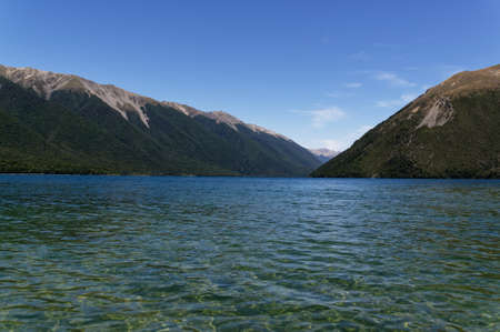 The clear waters of Lake Rotoiti invite you in for a swim, they are surrounded by mountains.の写真素材