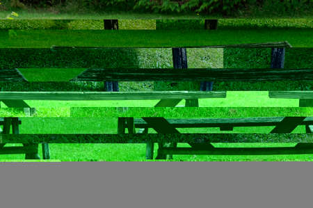 A traditional wooden New Zealand picnic table may have seen better days but is still functionalの写真素材