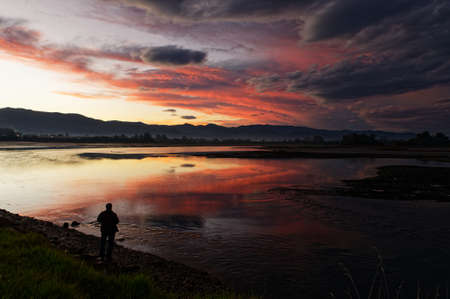 Dark clouds gather during sunset overlooking the seaの写真素材