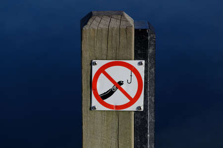 A sign telling people that fishing for eels is not permitted at Lake Rotoiti, Nelson Lakes National Parkの写真素材