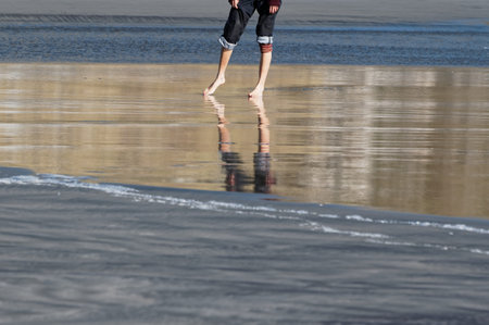 A summer's day invites rolled up jeans and getting your feet wet at the beach.