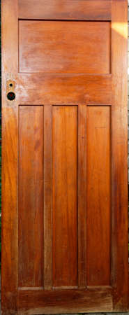 A renovation project has started on a wooden panel door. It has had it's lock and door handle removed.の写真素材