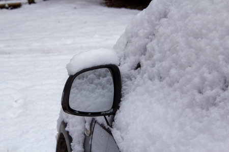 Mirror of a four-wheel drive car covered with snowの写真素材