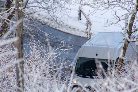 A courier van is delivering delivering a package
