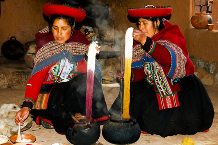 CUZCO, PERU - May 1, 2009: Women naturally dyeing wool in pots