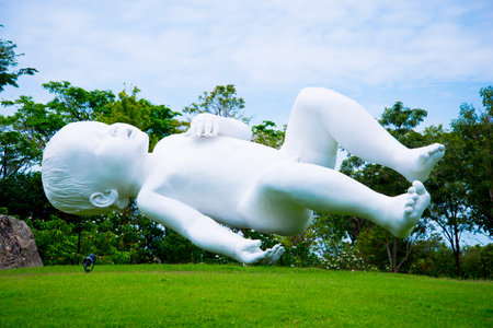 SINGAPORE CITY, SINGAPORE - April 12, 2019: "Planet" sculpture is an oversized baby floating in the air created by Marc Quinnのeditorial素材