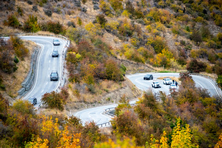Autumn road in the mountains. View from the top of the mountain.