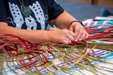 Close up of a woman working on a loom in her workshopの写真素材