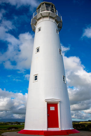 lighthouse on the north coast of ireland with blue sky and cloudsの写真素材