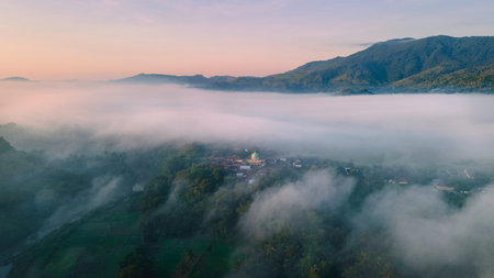 Aerial view, a village covered in a sea of â€‹â€‹mist in the morning with a view of the...