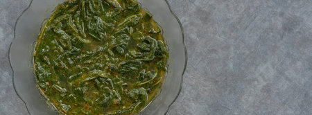 cassava leaf vegetable curry served with a mixture of Indonesian spices.