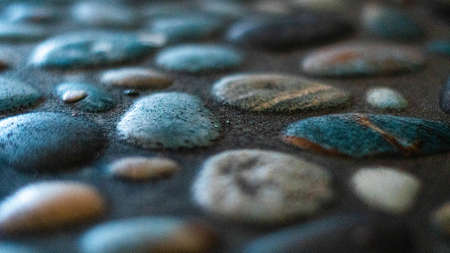 Close up of wet pebbles on the floor. Selective focus.の写真素材