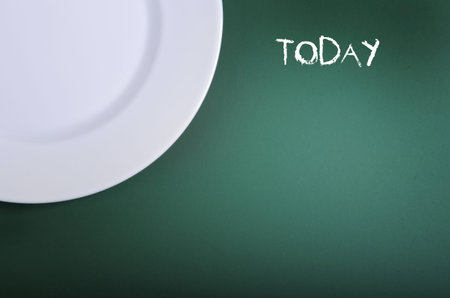 White empty plate on chalkboardの写真素材