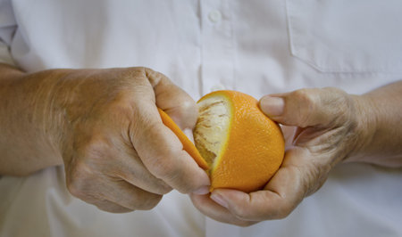Woman hands peel orangeの写真素材